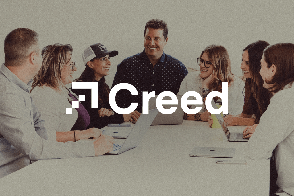Company logo with image image of Creed employees in background
