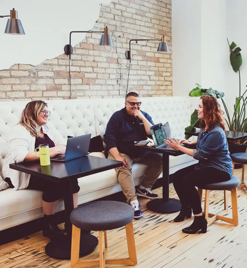 Coworkers talking at office benches