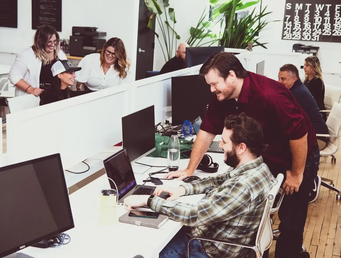 Developers looking at a laptop together