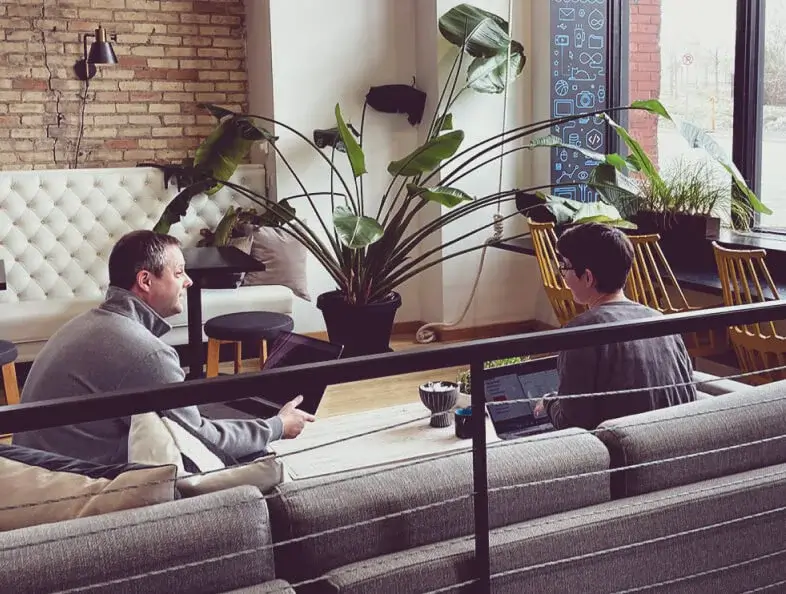 Two colleagues chatting in an office