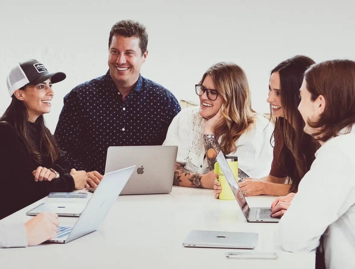 Coworkers laughing around a table