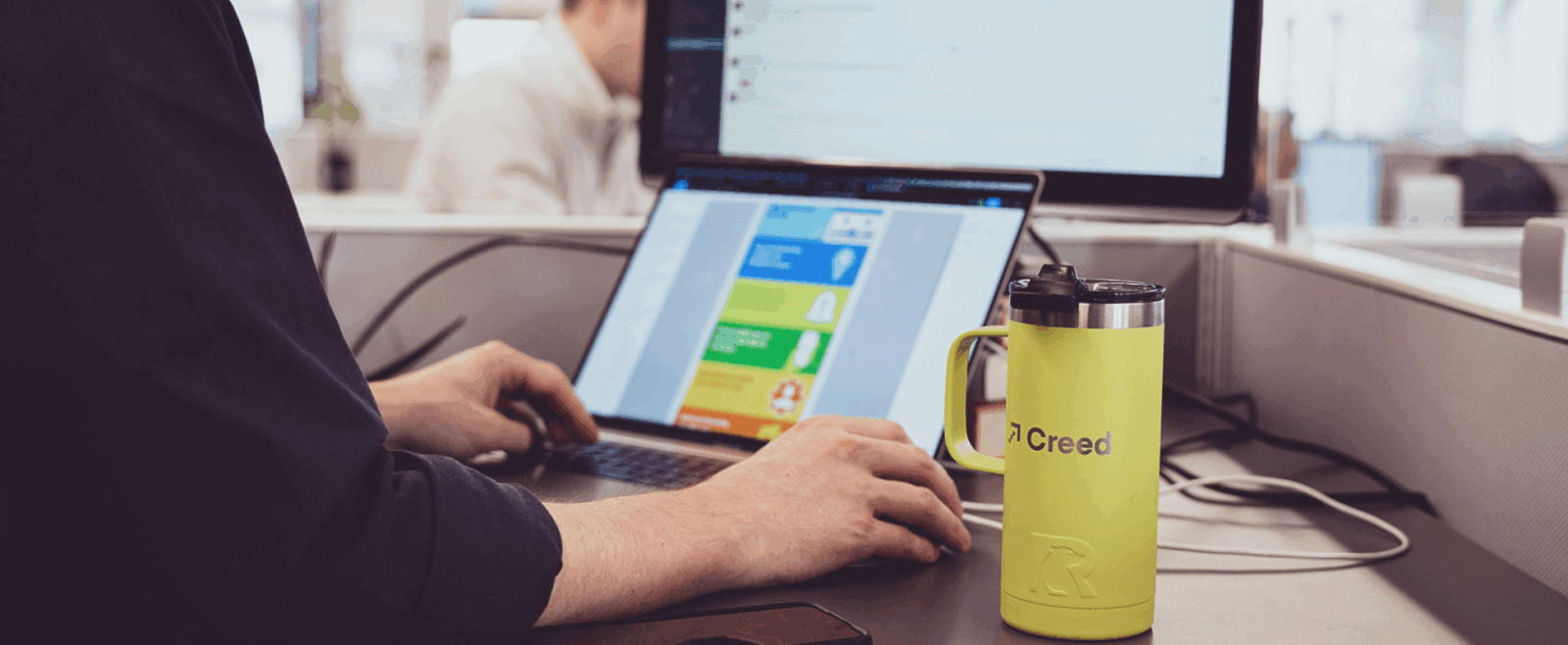 Creed employee at a computer