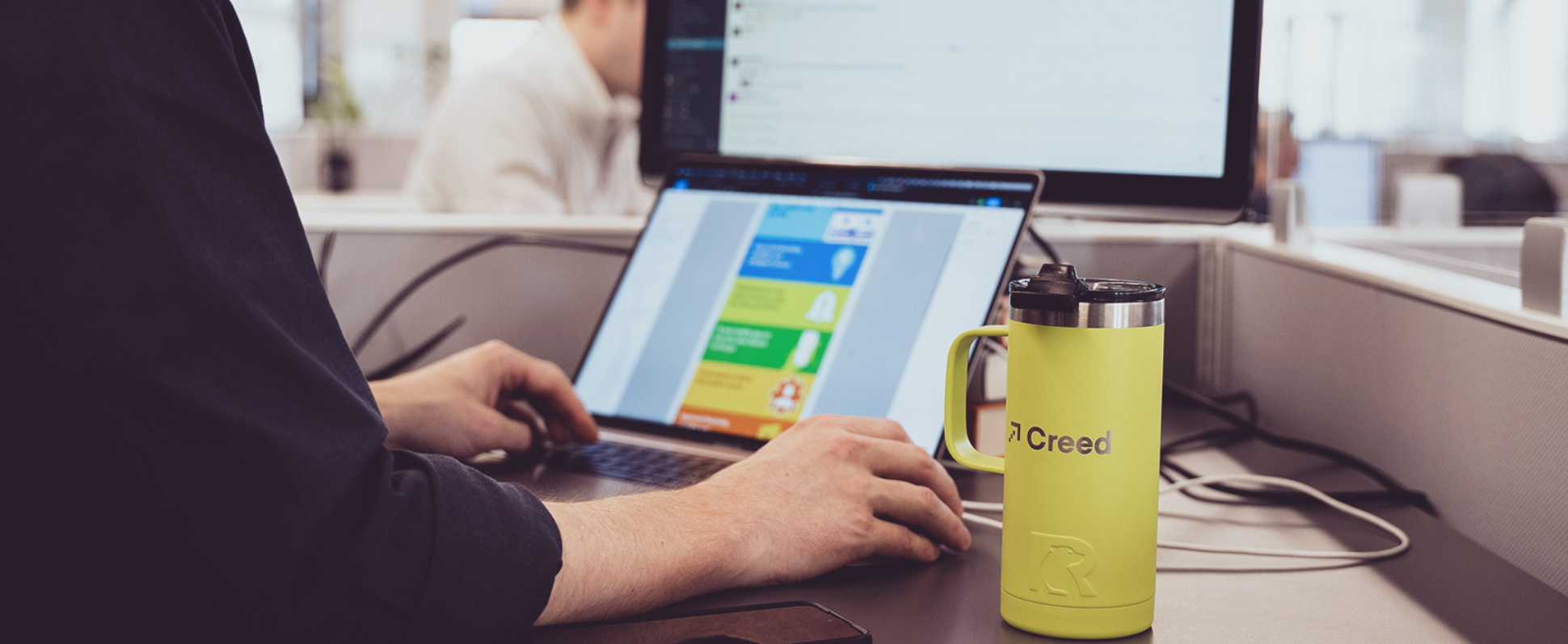 Creed employee at a computer