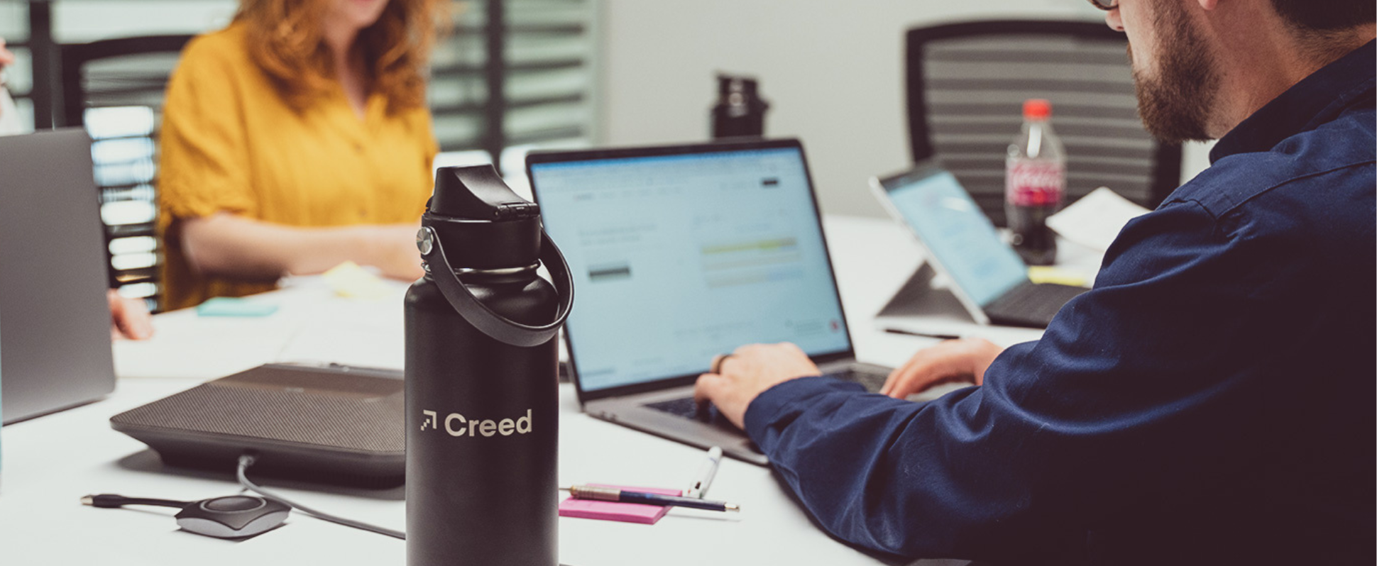 Creed employees working at a computer