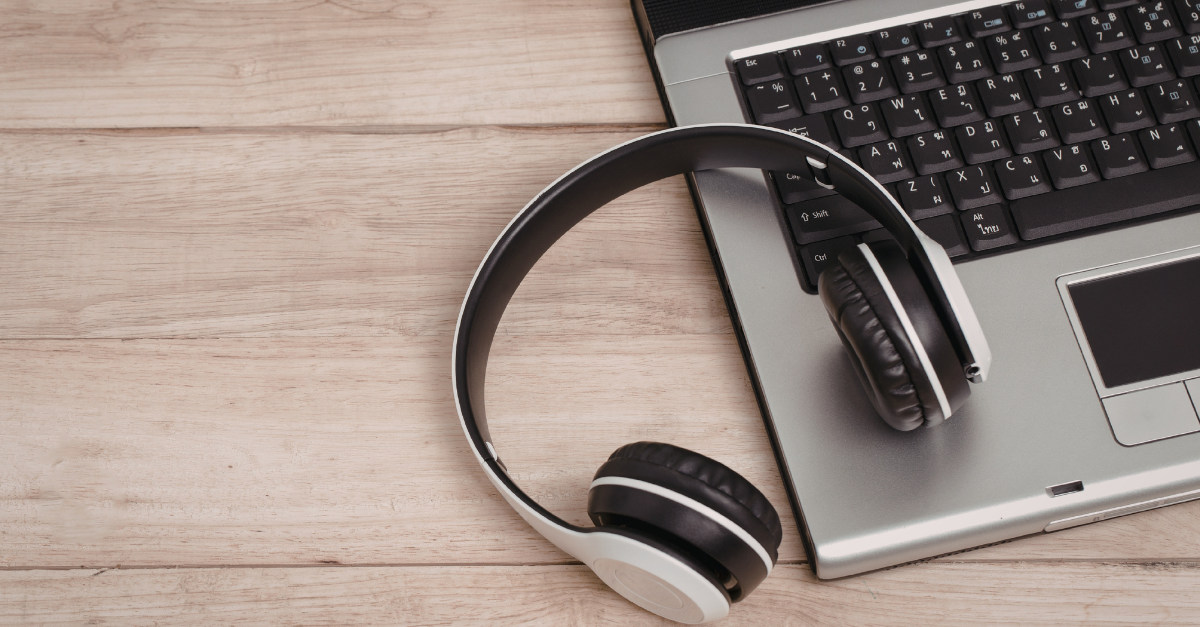 laptop with headphones next to it