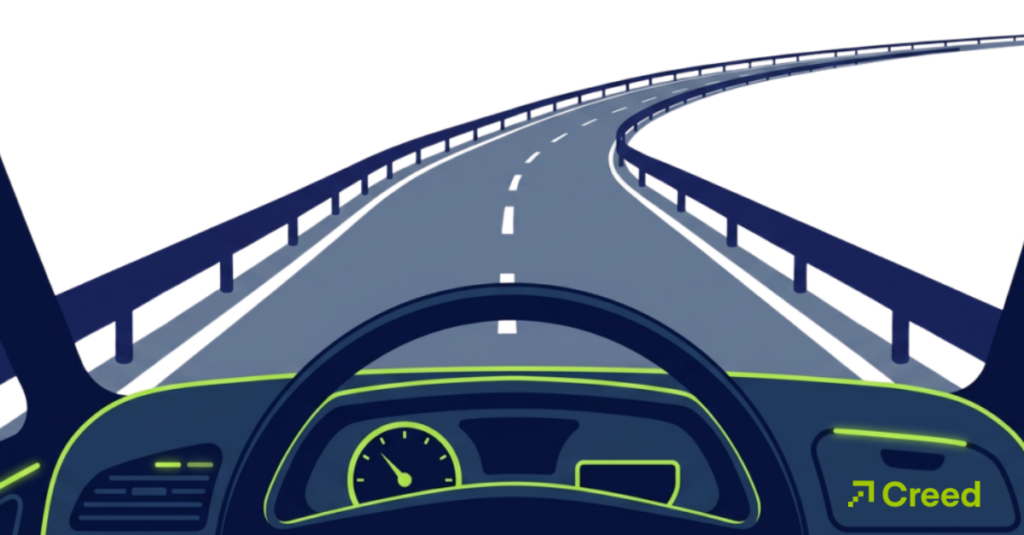 Graphic of steering wheel and dashboard heading down curved road with guardrails